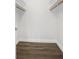 Empty walk-in closet with wood-look floors and shelving at 952 N Fairbairn Dr, Deltona, FL 32725