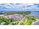 Expansive aerial photograph of a white condo building near the water, with city views in the distance at 1 John Anderson Dr # 3170, Ormond Beach, FL 32176