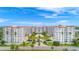 An aerial view of the condo complex with palm trees and a swimming pool in the center courtyard at 1 John Anderson Dr # 3170, Ormond Beach, FL 32176
