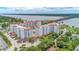 Aerial view of white condominium buildings with terracotta tile roofs near the Halifax River at 1 John Anderson Dr # 3170, Ormond Beach, FL 32176