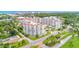A bird's-eye view of the condos, green landscapes, nearby buildings, and the ocean in the distance at 1 John Anderson Dr # 3170, Ormond Beach, FL 32176