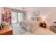 Cozy bedroom with balcony, ceiling fan, and plush decor at 1 John Anderson Dr # 3170, Ormond Beach, FL 32176