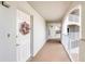 Inviting condo entrance with a decorative door wreath and a well-lit, open hallway at 1 John Anderson Dr # 3170, Ormond Beach, FL 32176