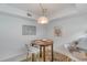 A cozy dining area features a round wooden table, plush chairs, and a charming stained-glass pendant light at 1 John Anderson Dr # 3170, Ormond Beach, FL 32176