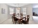 Bright dining room with a classic chandelier over a wooden table set for four at 1 John Anderson Dr # 3170, Ormond Beach, FL 32176