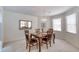 Bright dining room with a chandelier and a mirror reflecting a wooden table set for four at 1 John Anderson Dr # 3170, Ormond Beach, FL 32176