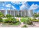 This is a beautifully landscaped exterior view of the condo, complete with a pool and lush greenery at 1 John Anderson Dr # 3170, Ormond Beach, FL 32176