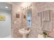 Quaint half bathroom offers floral wallpaper and a pedestal sink at 1 John Anderson Dr # 3170, Ormond Beach, FL 32176