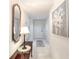 Bright condo hallway with tile flooring, a decorative table, and a painting enhancing the space at 1 John Anderson Dr # 3170, Ormond Beach, FL 32176