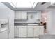 Bright white kitchen featuring white cabinets, and stainless steel appliances with a view to the living area at 1 John Anderson Dr # 3170, Ormond Beach, FL 32176