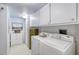 Bright laundry room with white cabinets and washer and dryer at 1 John Anderson Dr # 3170, Ormond Beach, FL 32176