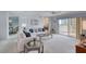 Bright living room features balcony access, neutral carpet and a ceiling fan at 1 John Anderson Dr # 3170, Ormond Beach, FL 32176