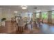 Well-lit lobby area with hardwood floors, tables and cushioned chairs for residents at 1 John Anderson Dr # 3170, Ormond Beach, FL 32176