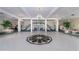 Grand lobby featuring a decorative floor mosaic, statement staircase, and elegant chandelier lighting at 1 John Anderson Dr # 3170, Ormond Beach, FL 32176