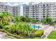 Condo exterior showcases a serene pool area surrounded by lush tropical landscaping and resort-style amenities at 1 John Anderson Dr # 3170, Ormond Beach, FL 32176