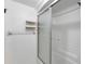 Bathroom showcasing a shower with sliding glass doors and wall-mounted shelves at 101 N Hill Ave # 6, Deland, FL 32724