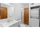 Bright bathroom featuring a washer/dryer, vanity, and a combined toilet and tub/shower at 101 N Hill Ave # 6, Deland, FL 32724
