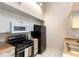 Kitchen featuring modern appliances, gas range and white cabinetry at 101 N Hill Ave # 6, Deland, FL 32724