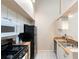Well-equipped kitchen with gas range, stainless steel sink, and white cabinetry at 101 N Hill Ave # 6, Deland, FL 32724