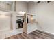 Open-concept living space featuring wood floors, kitchen bar, and access to a loft area at 101 N Hill Ave # 6, Deland, FL 32724