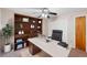 Well-lit office with built-in shelving, closet, large desk, and comfortable leather chair at 101 N Hill Ave # 6, Deland, FL 32724