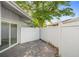 A view of the fenced in patio area with sliding glass door and landscaping at 101 N Hill Ave # 6, Deland, FL 32724