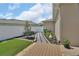A beautifully landscaped backyard with a stone walkway, colorful plants, and a manicured lawn at 1018 River Falls Cir, Deland, FL 32720