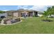 Expansive backyard featuring a serene patio area and a decorative bridge over a landscape bed at 1018 River Falls Cir, Deland, FL 32720