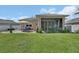 Large manicured lawn with screened-in patio at 1018 River Falls Cir, Deland, FL 32720