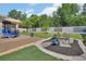 Manicured lawn features rock beds, a mini-bridge, colorful plants and vinyl fencing at 1018 River Falls Cir, Deland, FL 32720