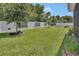 Wide lawn with vinyl fencing, and large shade trees at 1018 River Falls Cir, Deland, FL 32720