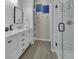 Modern bathroom with double vanity, updated fixtures, and walk-in shower with white subway tile at 1018 River Falls Cir, Deland, FL 32720