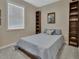 Bedroom with natural light, neutral walls, and shelving for displaying collectibles at 1018 River Falls Cir, Deland, FL 32720