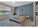 Cozy bedroom features stylish accent wall and a bright window at 1018 River Falls Cir, Deland, FL 32720