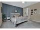 Cozy bedroom features stylish accent wall and a bright window at 1018 River Falls Cir, Deland, FL 32720