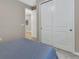 Bedroom with sliding door closet and light entering from an adjacent doorway at 1018 River Falls Cir, Deland, FL 32720