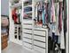 Spacious walk-in closet with custom shelving, drawers, hanging racks, and a place for shoes at 1018 River Falls Cir, Deland, FL 32720