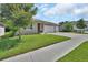 Well-manicured front lawn with an inviting entrance to the home at 1018 River Falls Cir, Deland, FL 32720