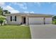 Charming single-story home with a well-manicured lawn and a spacious three-car garage at 1018 River Falls Cir, Deland, FL 32720