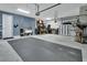 Spacious garage with high ceilings and ample storage and workspace, featuring a sink and epoxy flooring at 1018 River Falls Cir, Deland, FL 32720