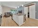 Bright open-concept kitchen features granite countertops and an island with seating at 1018 River Falls Cir, Deland, FL 32720