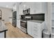Kitchen features granite countertops, stainless steel appliances, and white cabinets at 1018 River Falls Cir, Deland, FL 32720