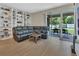 Cozy living room with built-in shelving and large sliding glass doors to the patio at 1018 River Falls Cir, Deland, FL 32720