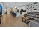 Open-concept kitchen and living area with a modern island, stainless appliances, and built-in shelving at 1018 River Falls Cir, Deland, FL 32720