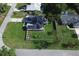 Aerial shot of a home with solar panels and a fenced yard, offering a sense of privacy and eco-friendliness at 1020 N Orange Ave, Orange City, FL 32763