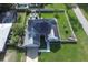 Aerial view of a home with solar panels, a well-maintained yard, and an inviting pool area at 1020 N Orange Ave, Orange City, FL 32763
