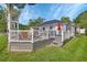 Exterior of home featuring a wooden deck, dining area, and well-maintained lawn at 1020 N Orange Ave, Orange City, FL 32763