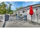 Backyard deck featuring outdoor dining set, grill, and shady umbrella at 1020 N Orange Ave, Orange City, FL 32763