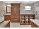 Bathroom featuring wood cabinetry, double shower, glass shelves, and updated fixtures at 1020 N Orange Ave, Orange City, FL 32763