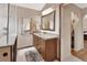 This bathroom features a vanity with a large mirror, a towel rack, and a glass shower at 1020 N Orange Ave, Orange City, FL 32763